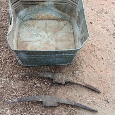 Metal wash tub with two vintage pickaxe heads
