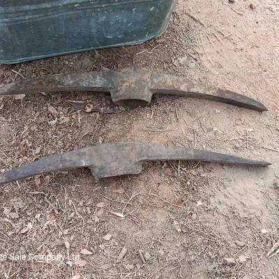 Metal wash tub with two vintage pickaxe heads