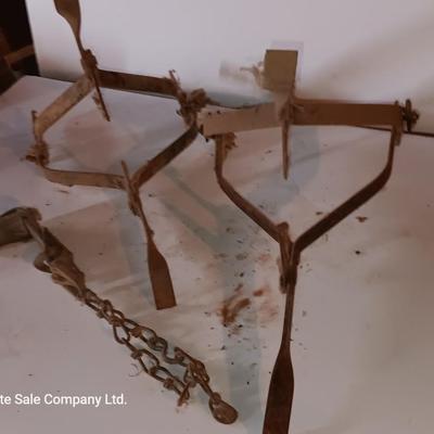 Two vintage metal traps with chain
