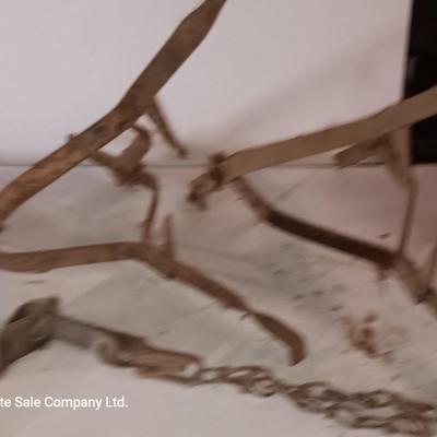 Two vintage metal traps with chain