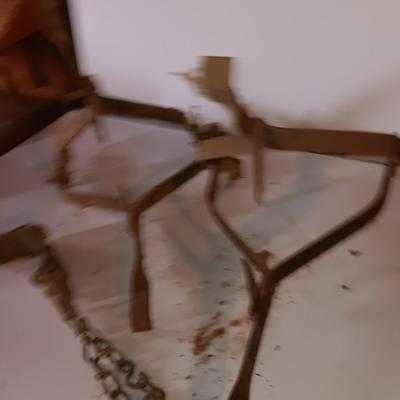 Two vintage metal traps with chain