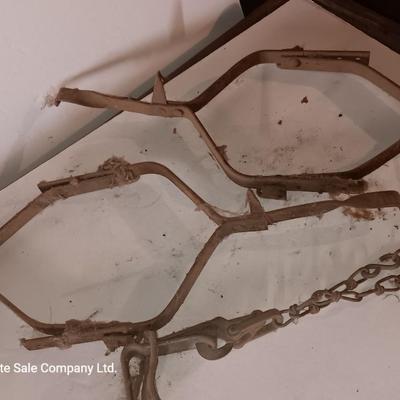 Two vintage metal traps with chain