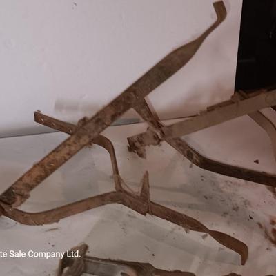 Two vintage metal traps with chain