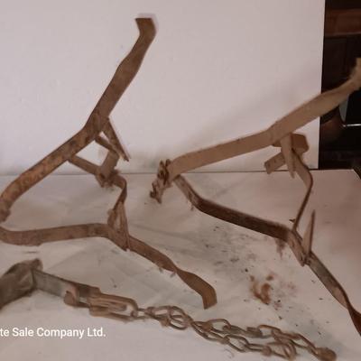 Two vintage metal traps with chain