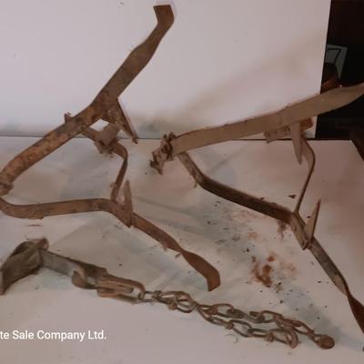 Two vintage metal traps with chain