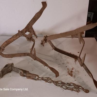 Two vintage metal traps with chain
