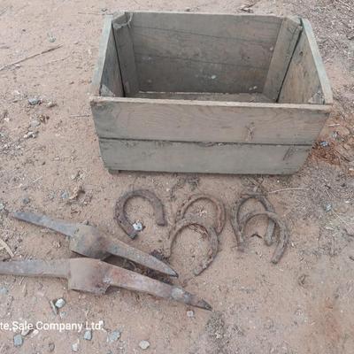 Wooden crate box with horseshoes and pickaxe heads