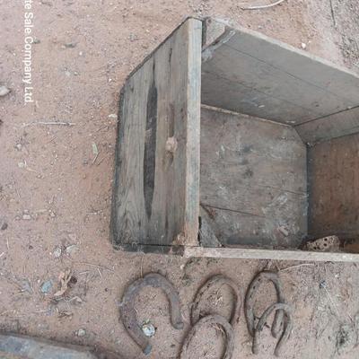 Wooden crate box with horseshoes and pickaxe heads