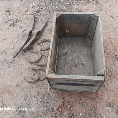Wooden crate box with horseshoes and pickaxe heads