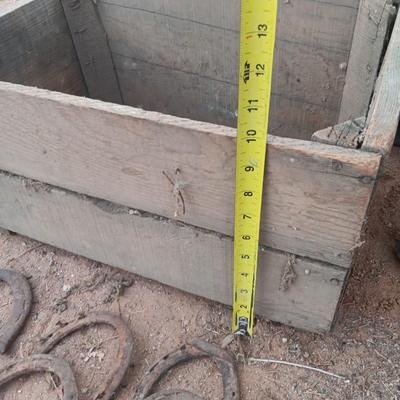 Wooden crate box with horseshoes and pickaxe heads