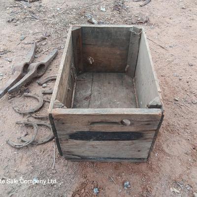 Wooden crate box with horseshoes and pickaxe heads