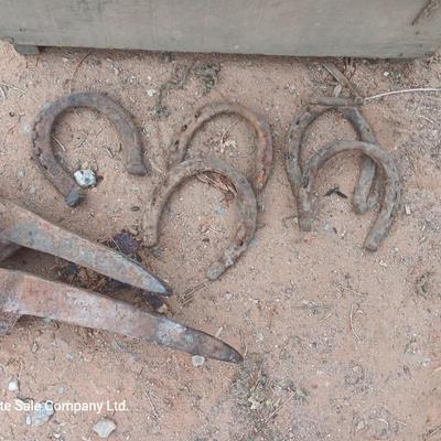 Wooden crate box with horseshoes and pickaxe heads