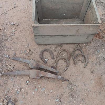 Wooden crate box with horseshoes and pickaxe heads