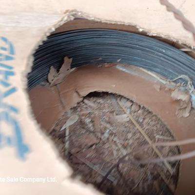 Partial roll of barbed wire and two partial boxes of HW Brand Bailing wire