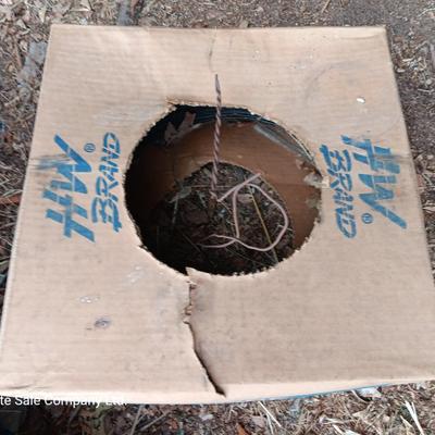 Partial roll of barbed wire and two partial boxes of HW Brand Bailing wire