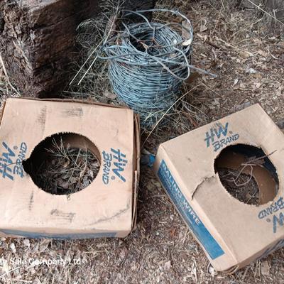 Partial roll of barbed wire and two partial boxes of HW Brand Bailing wire