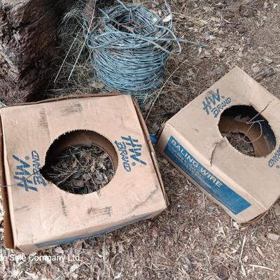Partial roll of barbed wire and two partial boxes of HW Brand Bailing wire