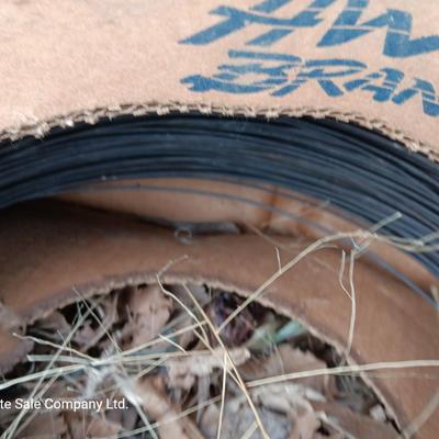 Partial roll of barbed wire and two partial boxes of HW Brand Bailing wire