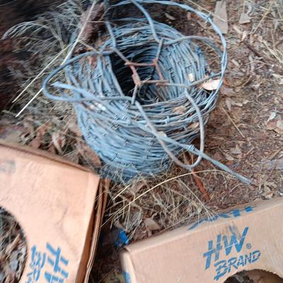Partial roll of barbed wire and two partial boxes of HW Brand Bailing wire