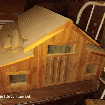Wooden hand-crafted barn with lights inside Horse stables