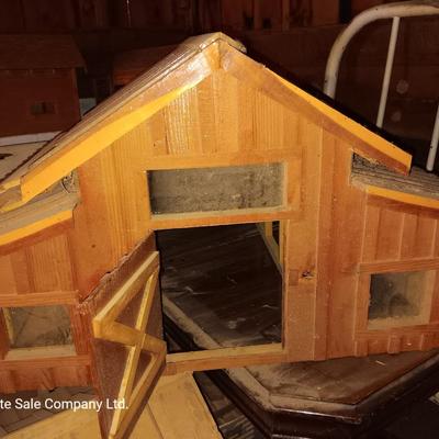 Wooden hand-crafted barn with lights inside Horse stables
