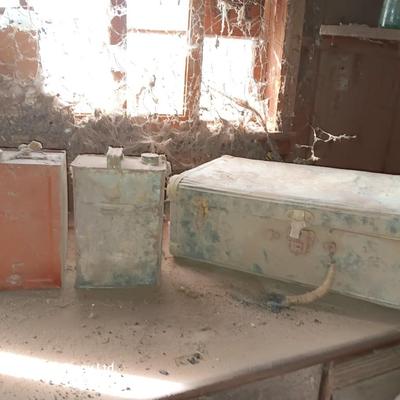 Two metal cans and an antique tin suitcase