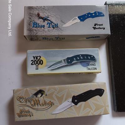 Laser art tile of a bobcat and three new pocketknives