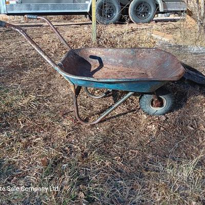 Old wheelbarrow for flowerbed of yard art