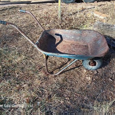 Old wheelbarrow for flowerbed of yard art