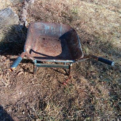 Old wheelbarrow for flowerbed of yard art