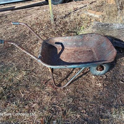 Old wheelbarrow for flowerbed of yard art