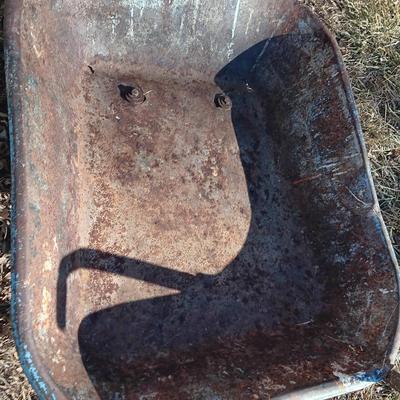 Old wheelbarrow for flowerbed of yard art