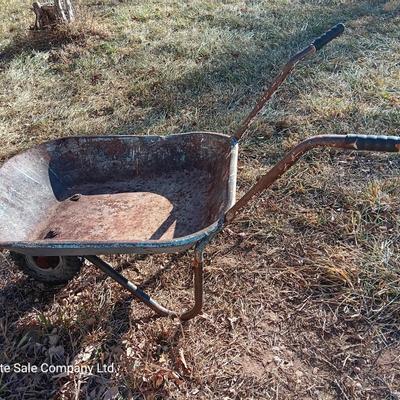 Old wheelbarrow for flowerbed of yard art