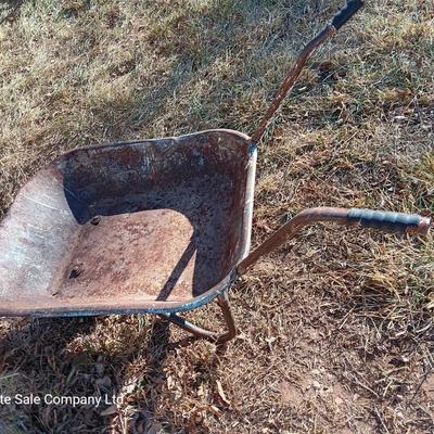 Old wheelbarrow for flowerbed of yard art