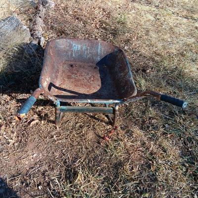 Old wheelbarrow for flowerbed of yard art