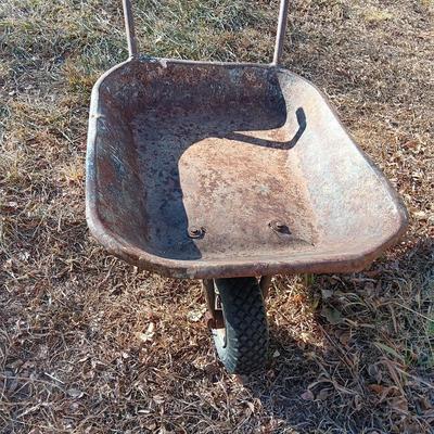Old wheelbarrow for flowerbed of yard art
