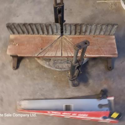 Antique cast - like Miter box with handsaw that has several blade attachments.