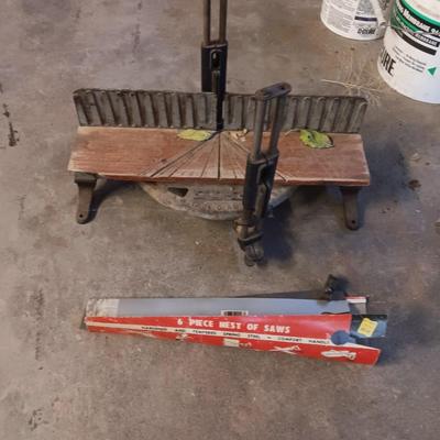 Antique cast - like Miter box with handsaw that has several blade attachments.