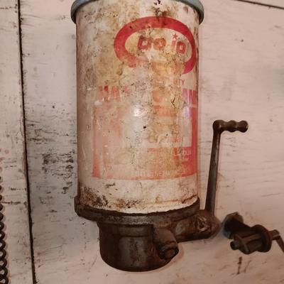 Antique can opener - hand cleaner dispenser - and pencil sharpener with a grease gun