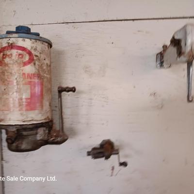 Antique can opener - hand cleaner dispenser - and pencil sharpener with a grease gun