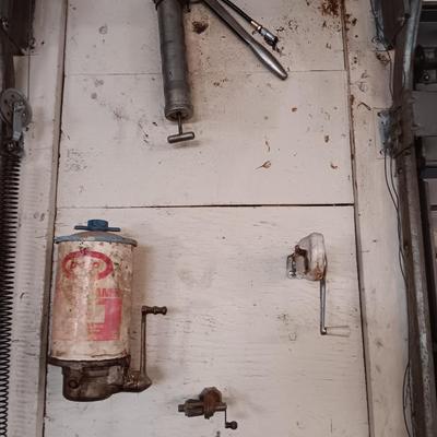 Antique can opener - hand cleaner dispenser - and pencil sharpener with a grease gun