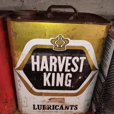Vintage tin cans partially full of chemicals with metal bucket