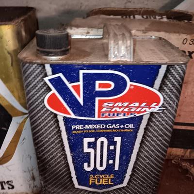 Vintage tin cans partially full of chemicals with metal bucket