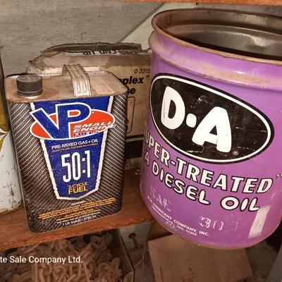 Vintage tin cans partially full of chemicals with metal bucket