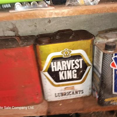 Vintage tin cans partially full of chemicals with metal bucket