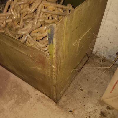 Green metal box full of assorted chains