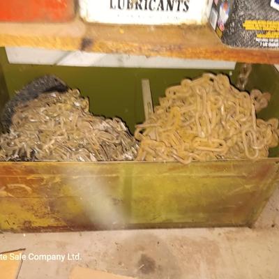 Green metal box full of assorted chains