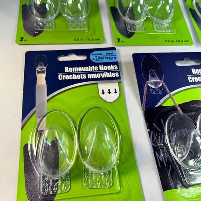 GROUP OF CLEAR REMOVABLE WALL HOOKS NEW IN PACKAGES, 11 COUNT