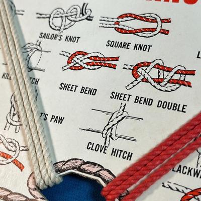 "FORTY KNOTS- LEARN TO TIE THEM" CARD WITH RED AND WHITE PRACTICE ROPE
