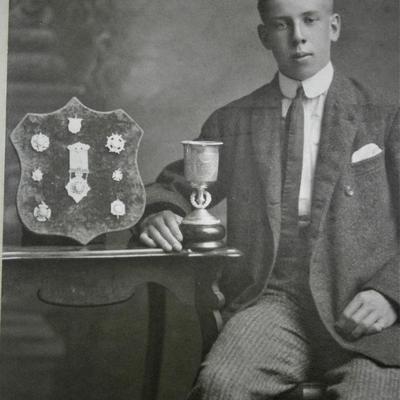 Image of Young Man Posing with Trophy Cup